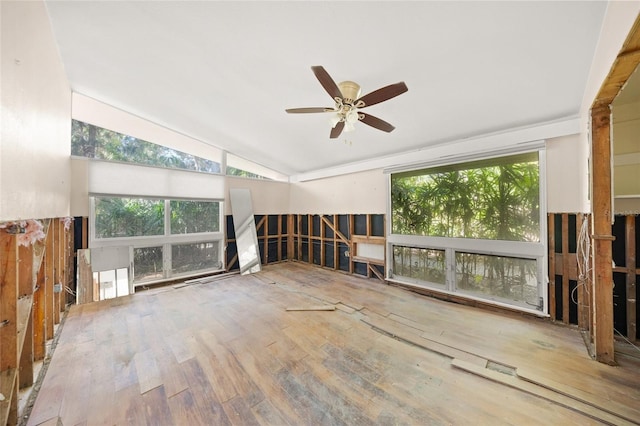 unfurnished living room with hardwood / wood-style flooring, lofted ceiling, and ceiling fan