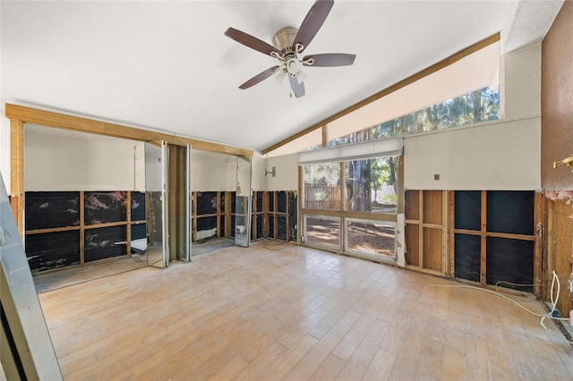 interior space featuring hardwood / wood-style flooring, ceiling fan, and vaulted ceiling