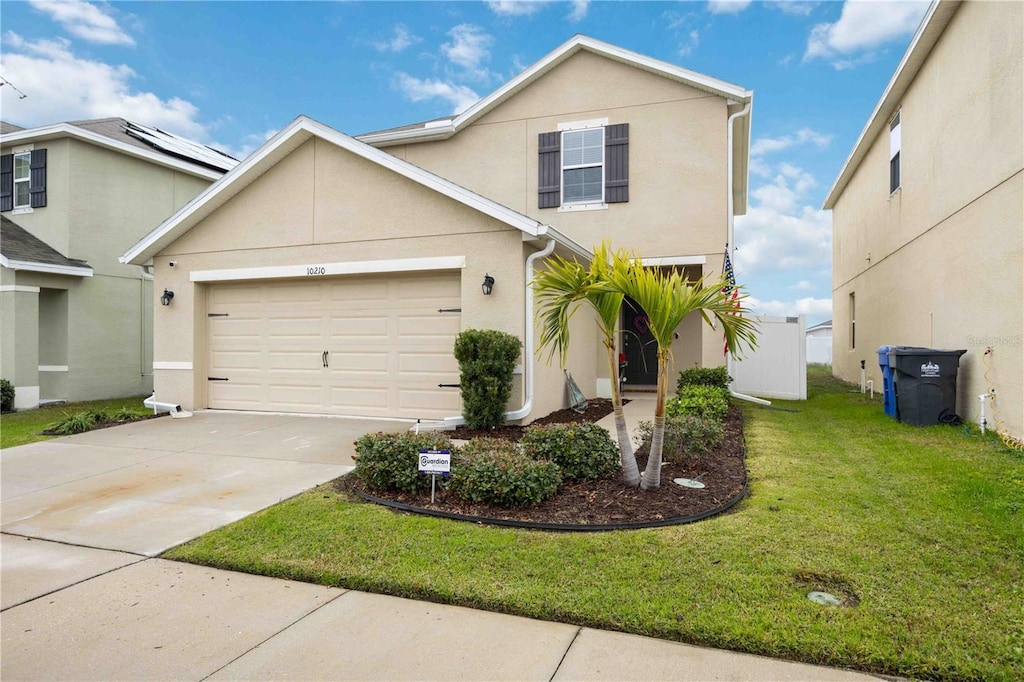 view of front property featuring a garage and a front lawn