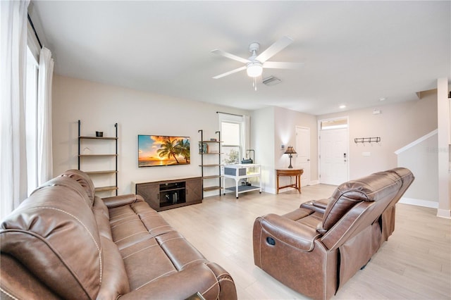 living room with ceiling fan and light wood-type flooring