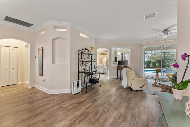 sitting room featuring ornamental molding, light hardwood / wood-style floors, and ceiling fan