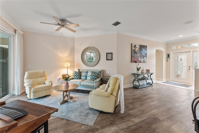 living room with crown molding, wood-type flooring, and ceiling fan