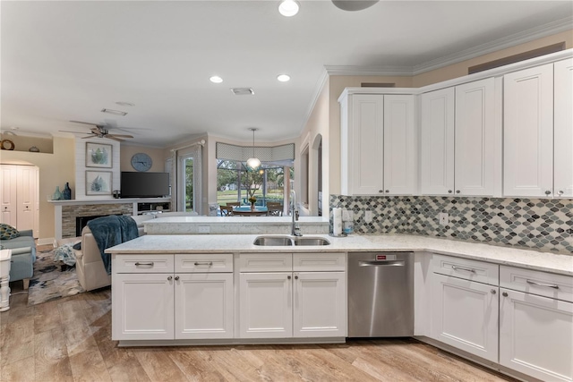 kitchen with white cabinetry, dishwasher, sink, and light hardwood / wood-style flooring