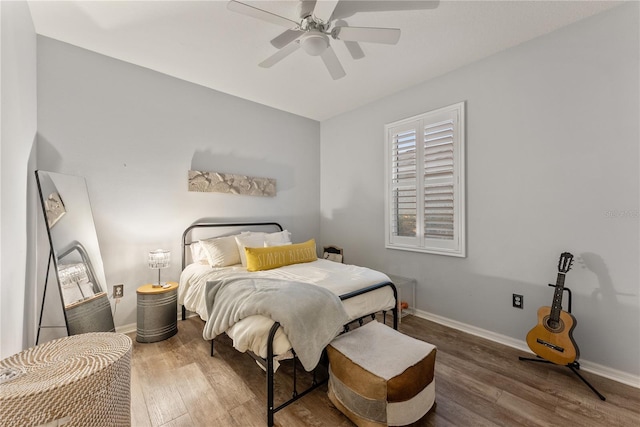 bedroom featuring hardwood / wood-style flooring and ceiling fan