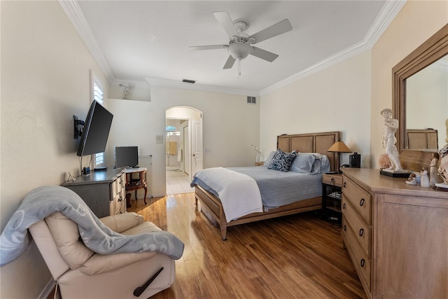 bedroom with ceiling fan, ornamental molding, ensuite bathroom, and wood-type flooring