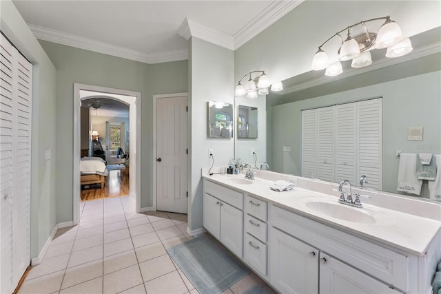 bathroom with tile patterned flooring, vanity, and ornamental molding