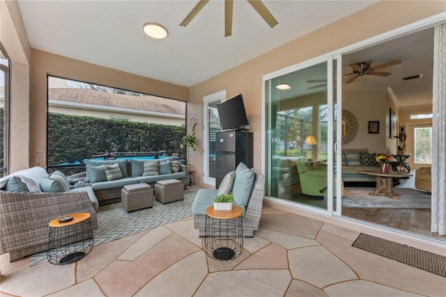 sunroom featuring ceiling fan