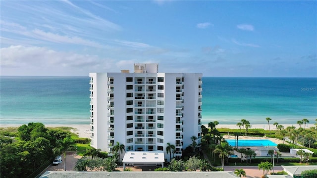 view of property featuring a view of the beach and a water view