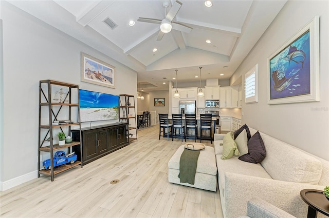 living room featuring beamed ceiling, ceiling fan, high vaulted ceiling, and light wood-type flooring