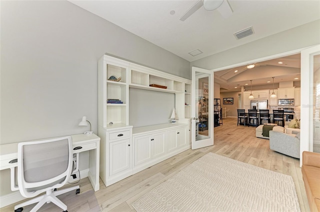 office space featuring lofted ceiling, light hardwood / wood-style floors, french doors, and ceiling fan