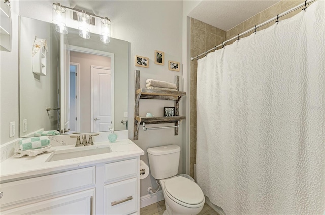 bathroom featuring vanity, a shower with shower curtain, and toilet