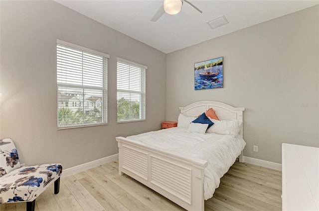 bedroom with light hardwood / wood-style floors and ceiling fan