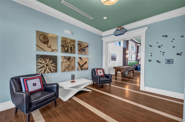 living area featuring hardwood / wood-style flooring and crown molding