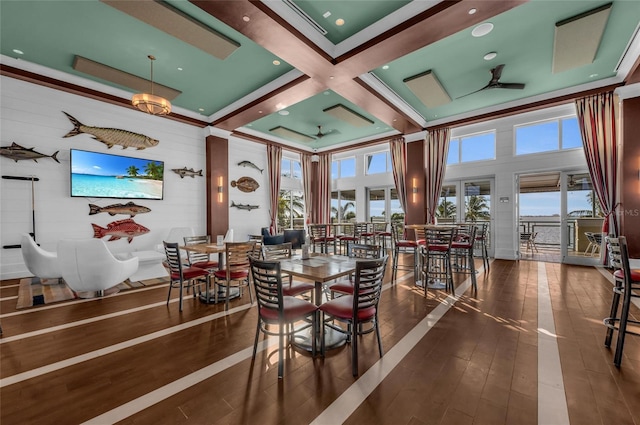 dining space featuring a wealth of natural light, coffered ceiling, dark wood-type flooring, and ceiling fan