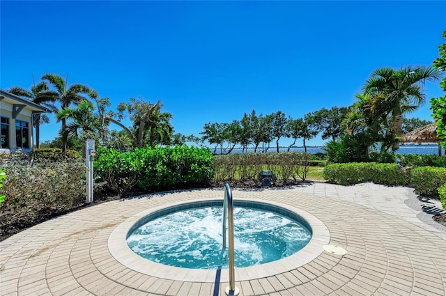 view of pool with an in ground hot tub