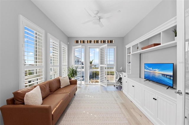 living room with ceiling fan and light wood-type flooring