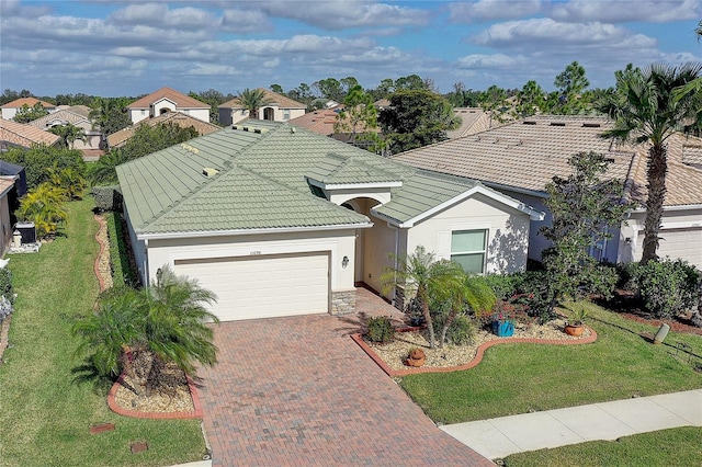 view of front of property with a garage and a front yard