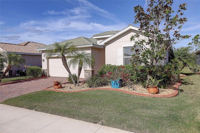 view of front of house featuring a garage and a front yard