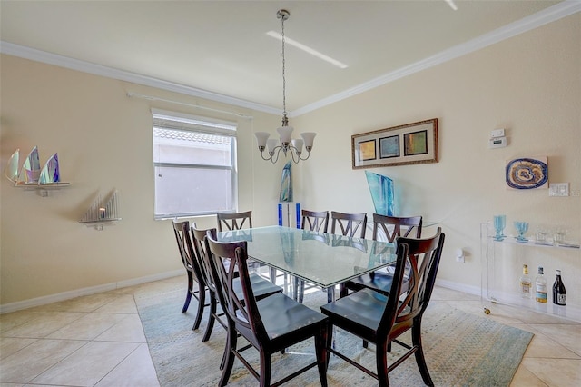 tiled dining area featuring ornamental molding and a chandelier