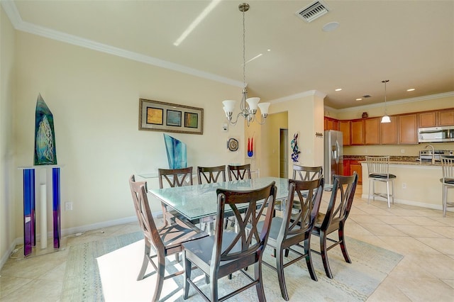 dining room featuring crown molding, a chandelier, and light tile patterned flooring