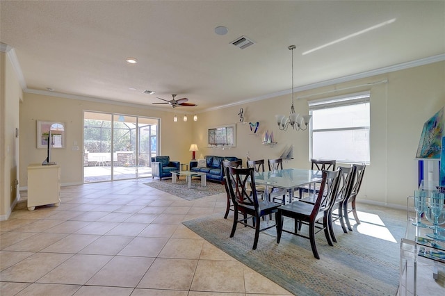 dining space with ceiling fan with notable chandelier, ornamental molding, and light tile patterned flooring