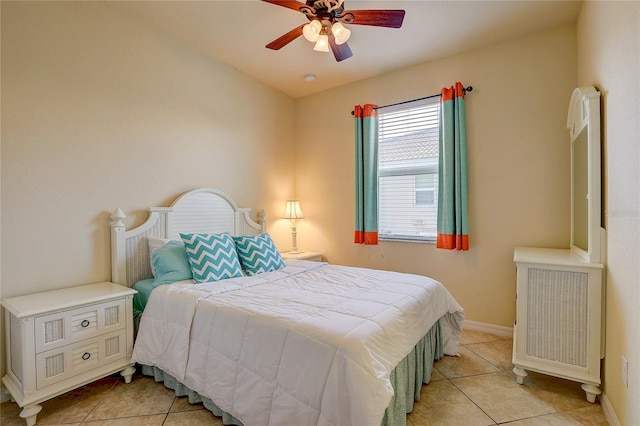 tiled bedroom with radiator and ceiling fan