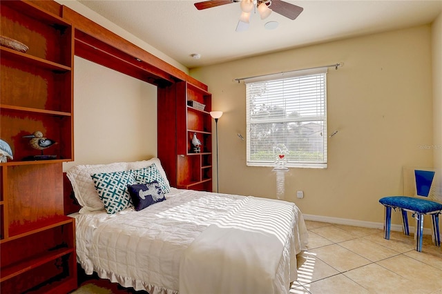 tiled bedroom featuring ceiling fan