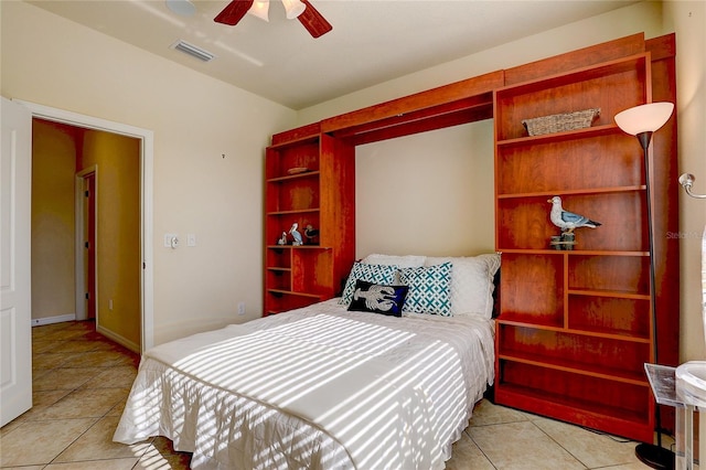 tiled bedroom featuring ceiling fan