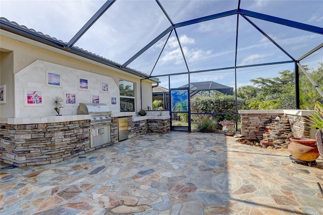 view of patio with grilling area, exterior kitchen, and glass enclosure