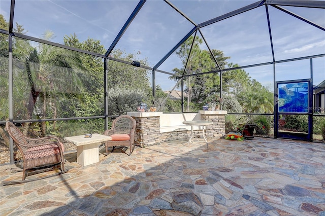 view of patio featuring a lanai