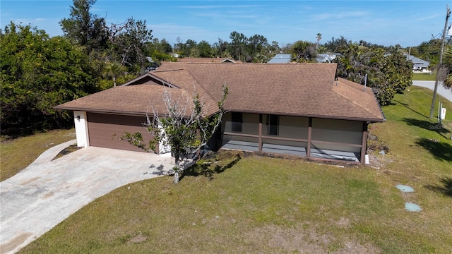 view of front of house with a garage and a front lawn