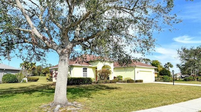 view of front of home with a garage and a front lawn