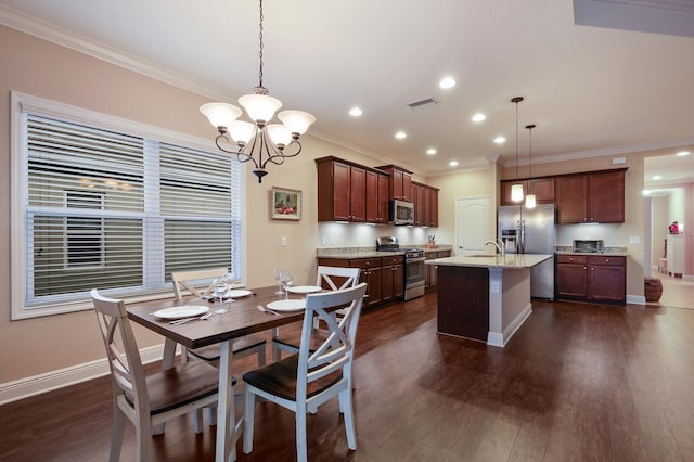 dining area with sink, ornamental molding, a notable chandelier, and dark hardwood / wood-style flooring