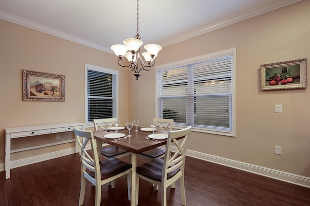 dining room featuring dark wood-type flooring, crown molding, and a chandelier