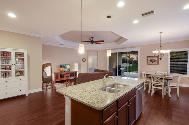 kitchen featuring decorative light fixtures, dark hardwood / wood-style flooring, sink, a raised ceiling, and crown molding