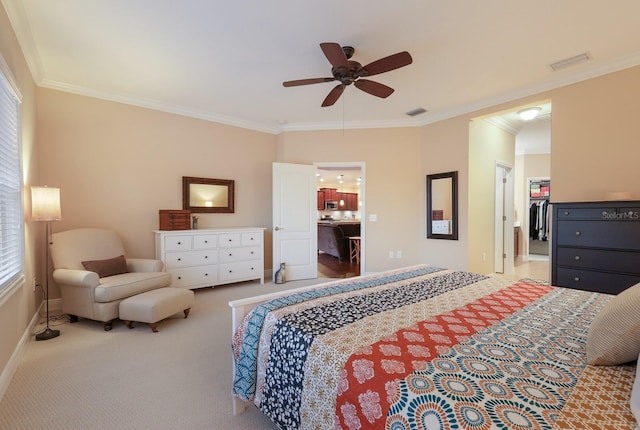 bedroom with a walk in closet, ensuite bath, a closet, ceiling fan, and crown molding