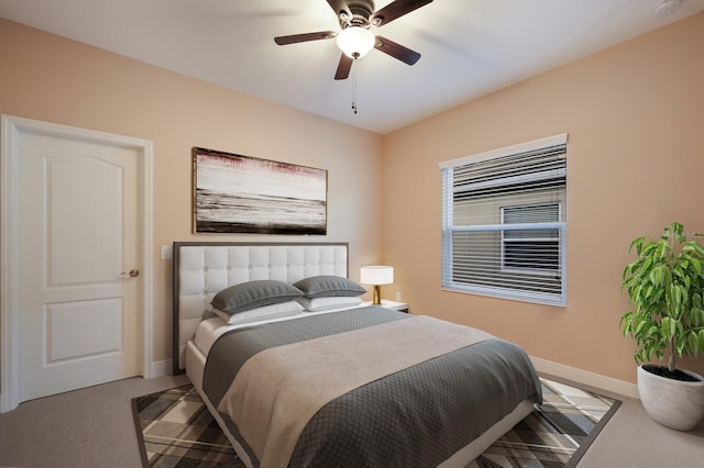 bedroom with ceiling fan and light carpet