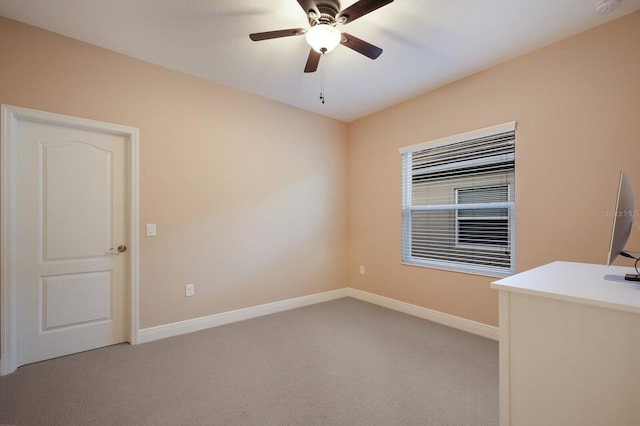 unfurnished office featuring light colored carpet and ceiling fan