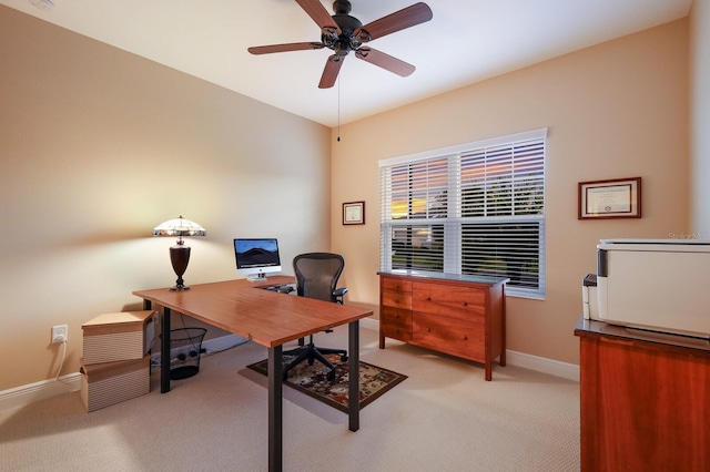 carpeted office space with ceiling fan