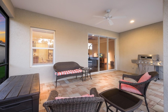 patio terrace at dusk with ceiling fan and a grill