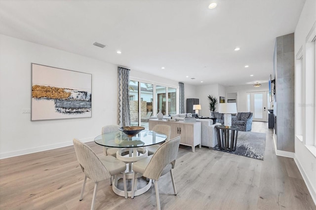 dining area with light hardwood / wood-style floors