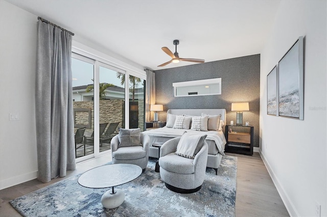 bedroom featuring ceiling fan, access to exterior, and light wood-type flooring