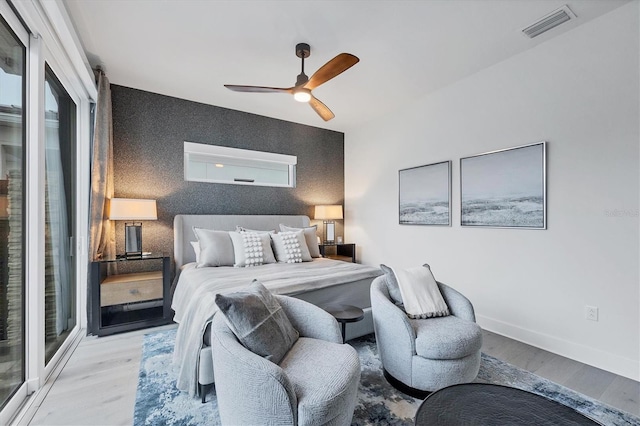 bedroom with ceiling fan and light wood-type flooring