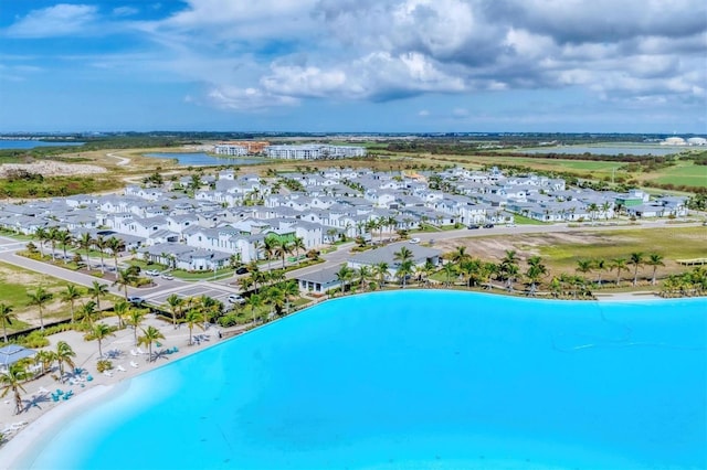 aerial view with a water view and a beach view