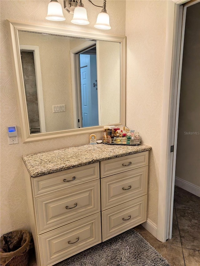 bathroom featuring vanity, tile patterned flooring, and a notable chandelier