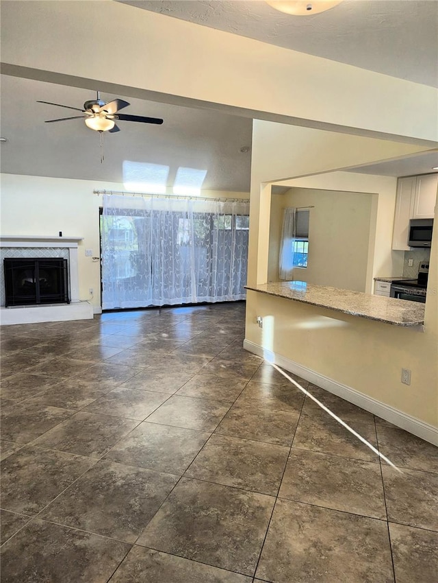 unfurnished living room featuring ceiling fan