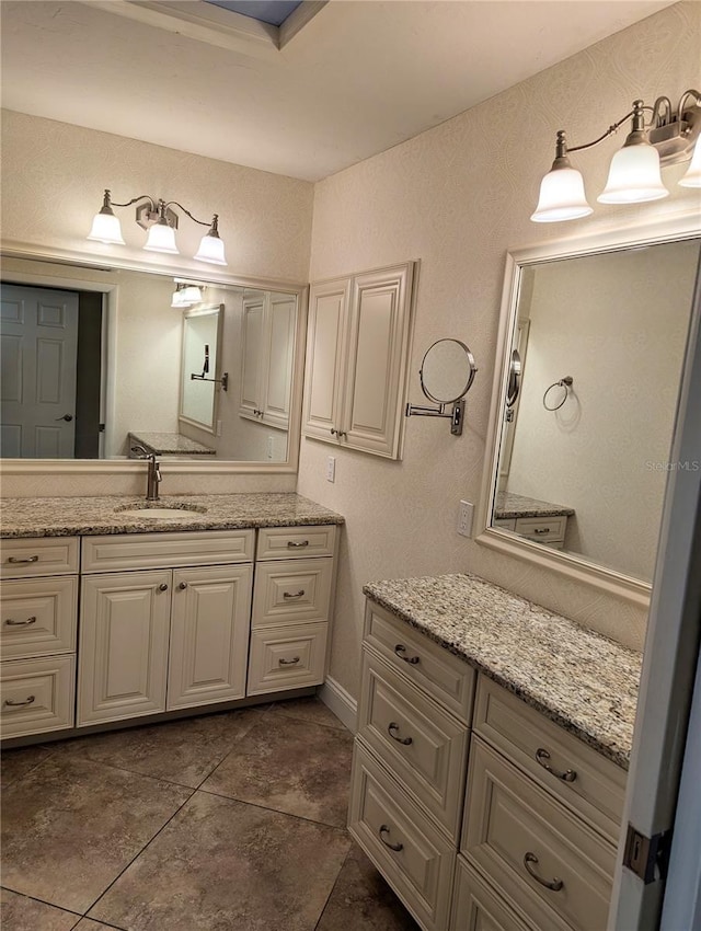 bathroom featuring tile patterned flooring and vanity