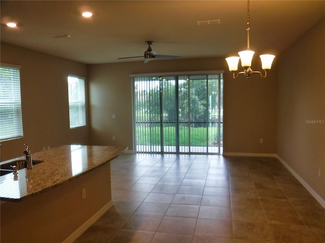 interior space with tile patterned flooring, sink, and ceiling fan with notable chandelier