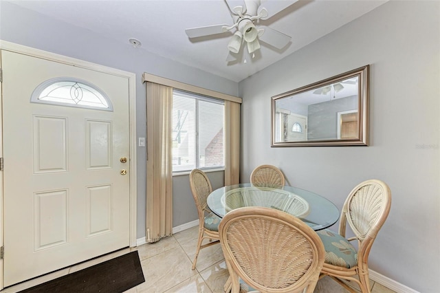 dining space with a healthy amount of sunlight, light tile patterned floors, and ceiling fan