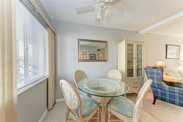 dining room featuring ceiling fan, beam ceiling, and light tile patterned floors